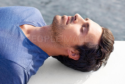 Buy stock photo Cropped shot of a handsome man lying down with his eyes closed