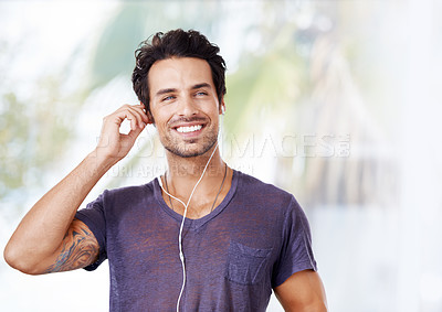 Buy stock photo Man, fashion and smile with earphones for music, podcast or streaming online on mockup. Male person, happy and listening to audio on headphones for enjoyment, fun and wellness outdoors in nature