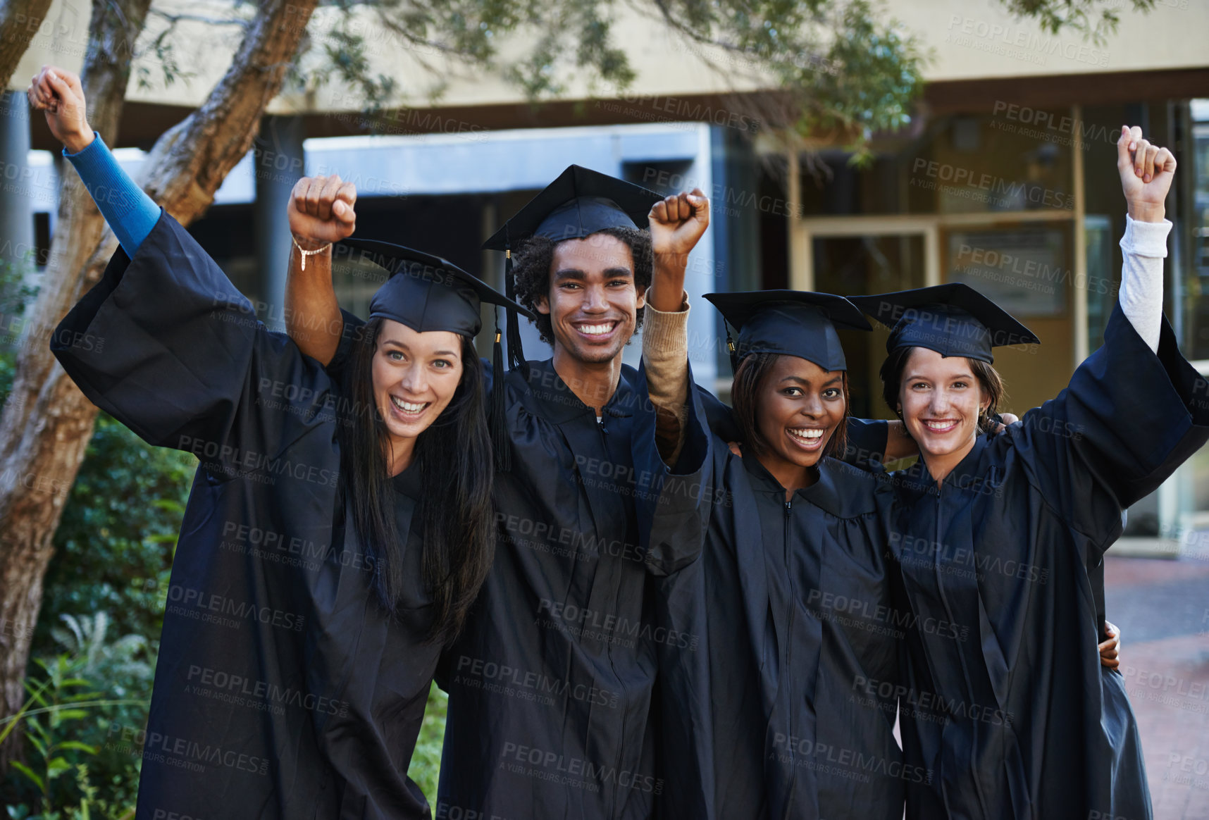 Buy stock photo A group of smiling college graduates celebrating their graduation