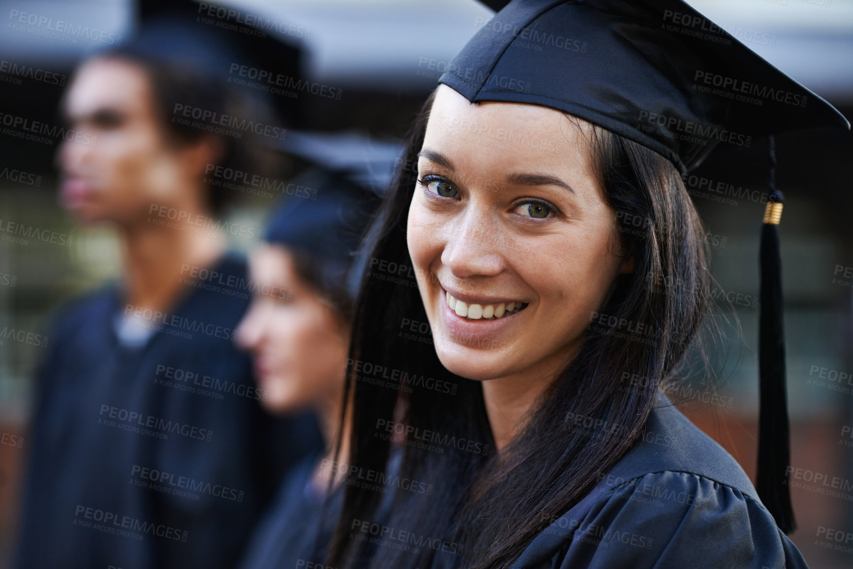 Buy stock photo Woman, student and portrait at graduation, college and university success or achievement. Happy female person, smile and pride at outdoor ceremony, higher education and knowledge in qualification