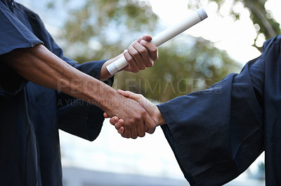 Buy stock photo Cropped shot of a graduate receiving a degree