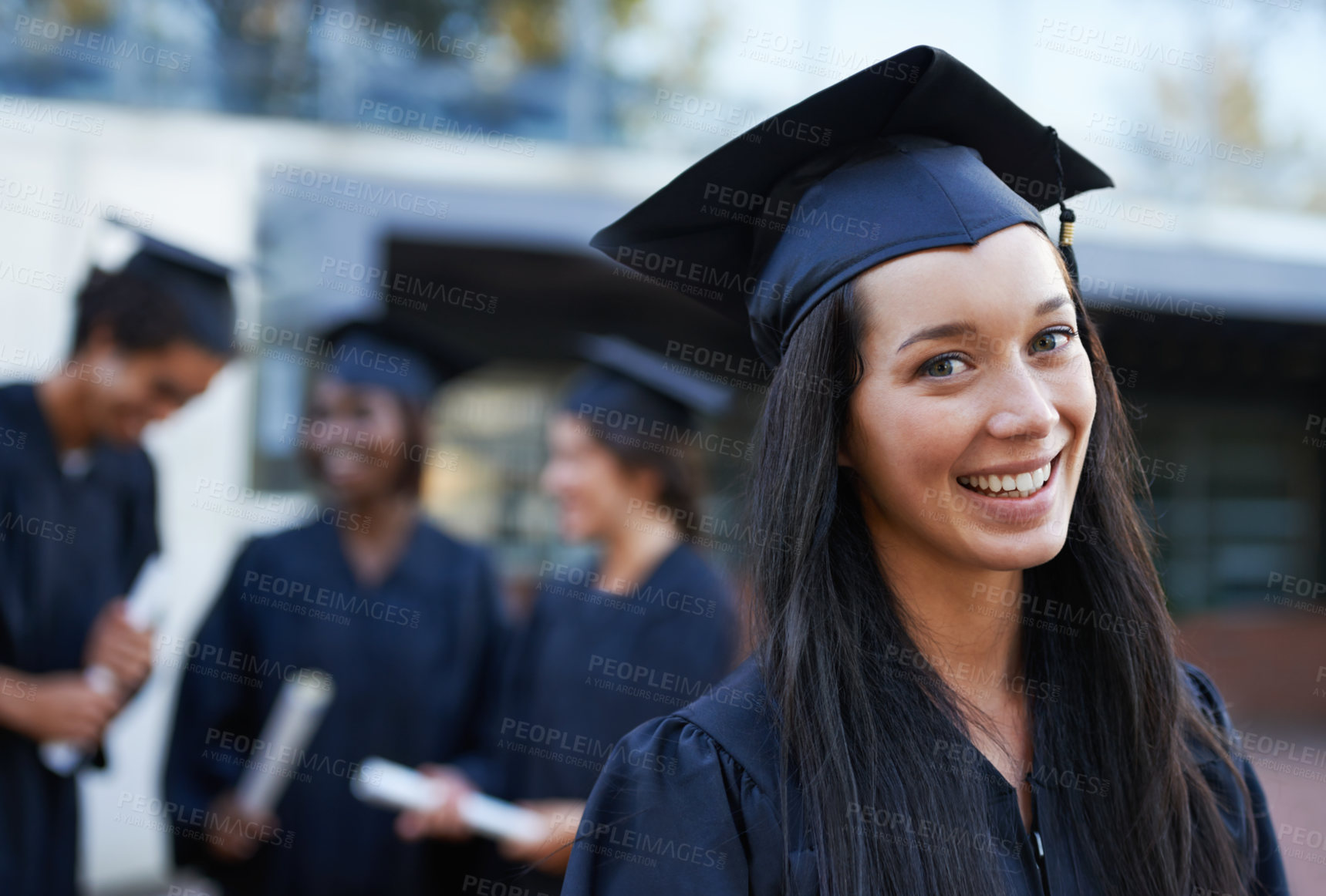 Buy stock photo Woman, student and portrait at graduation, milestone and university success or achievement. Happy female person, smile and pride at outdoor ceremony, higher education and knowledge in qualification