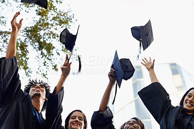Buy stock photo A group of smiling college graduates celebrating their graduation