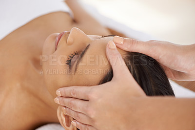 Buy stock photo A young woman enjoying a head and face massage at a spa