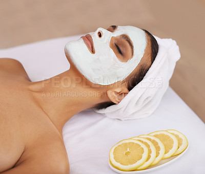 Buy stock photo Woman, face mask and cosmetology for skincare in spa, detox and cosmetic treatment for lemon facial. Person, relax and beauty with natural clay on skin, soothing and vitamin c for dermatology on bed