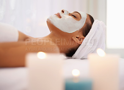 Buy stock photo Woman, face mask and candles for wellness in spa, detox and facial treatment with cosmetic product. Person, relax and dermatology with natural clay moisture on skin, calm and zen in spa for health