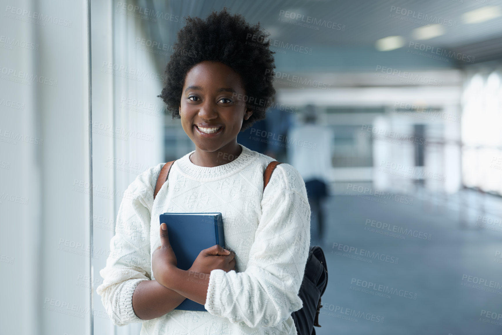 Buy stock photo African girl, portrait and hallway of college with smile from happiness of education in academy. Student, learning and notebook on hand with information for class in school campus and scholarship