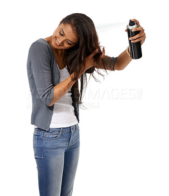 Buy stock photo A young ethnic woman using hairspray on her hair