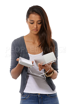 Buy stock photo Disappointed young woman holding an empty gift box against a white background