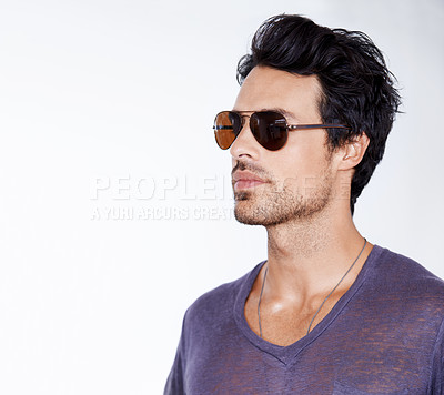 Buy stock photo Serious, fashion and man with sunglasses in studio with confidence, cool style and pride. Calm, person and face with shades in casual outfit for vacation in white background and relax in mock up
