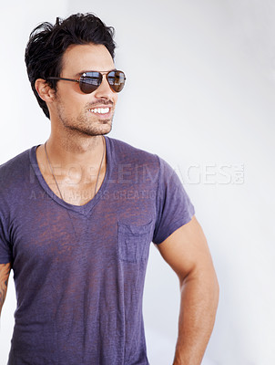 Buy stock photo Happy, man and fashion with sunglasses on wall outdoor with confidence, cool style and pride. Summer, holiday and person smile in casual outfit for vacation, break and relax on white background