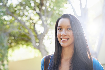Buy stock photo Cropped view of a young female student standing outdoors with her backpack
