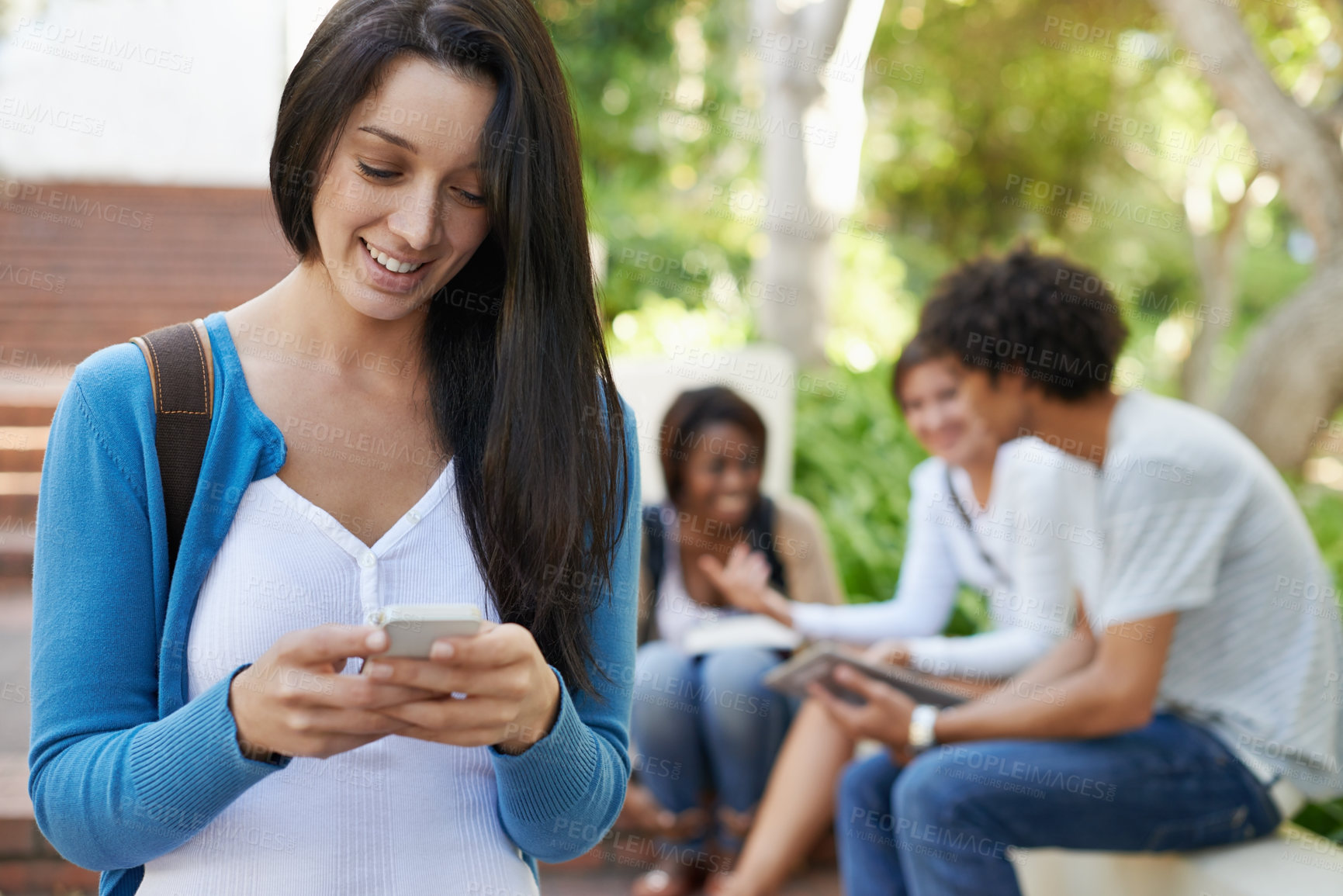 Buy stock photo Cropped view of a female college student using her phone while on campus