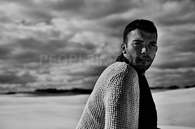 Buy stock photo Fashion, model and man in the desert thinking of travel in summer to relax on holiday vacation. Monochrome, black and white with face of person on sand dunes with confidence, freedom or cool style