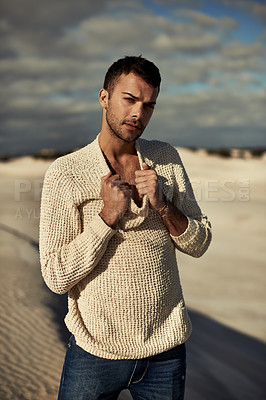 Buy stock photo A ruggedly handsome young man enjoying the beach