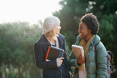 Buy stock photo Education, books and conversation with woman friends outdoor on campus together for learning or development. College, school or university with young student and best friend talking at recess break