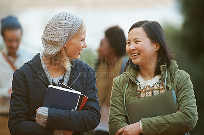 Buy stock photo Students, women and friends outdoor on campus for university, conversation and walking to class with smile. College, communication and books for studying, education and academic growth with talk