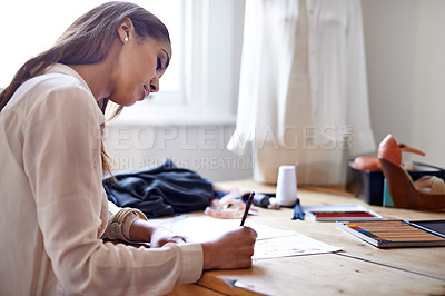 Buy stock photo A fashion designer drawing sketches in her office