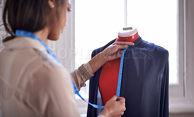 Buy stock photo A seamstress taking measurements for a garment she's making