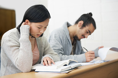 Buy stock photo Image of two students sitting in a lecture hall and studying for exams