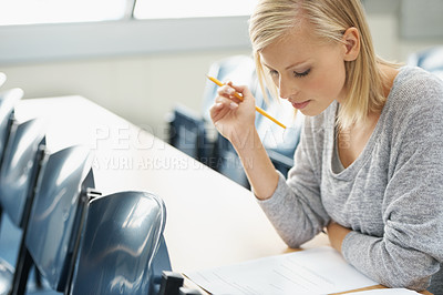 Buy stock photo A beautiful college student studying in a classroom