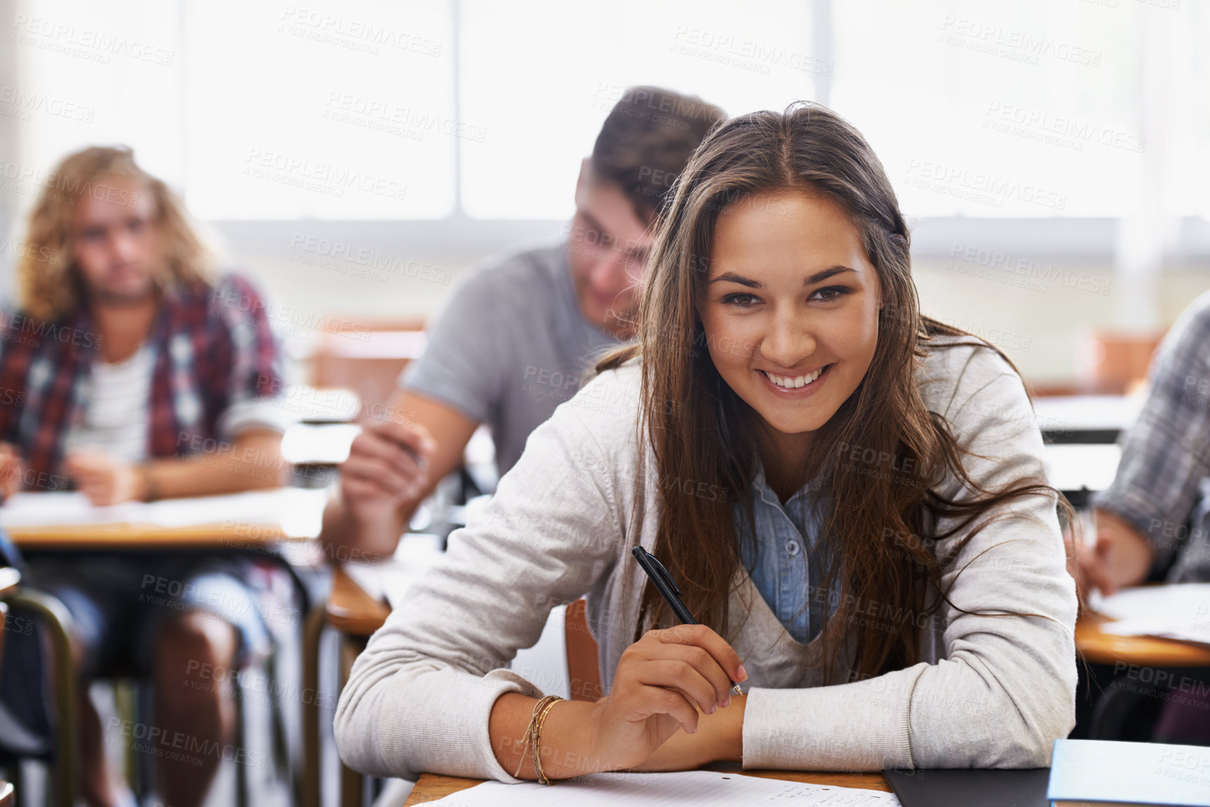 Buy stock photo Positive young students in a college classroom