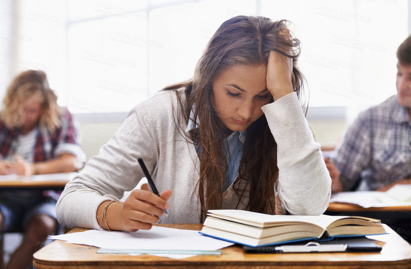 Buy stock photo University, classroom and woman with stress for exam, education and opportunity. College, learning and tired student with book, fatigue and anxiety for test, assessment or studying report with notes.