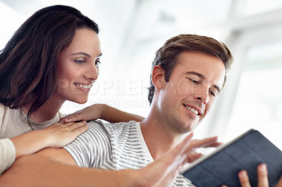 Buy stock photo Tablet, search and happy couple in a house with social media, streaming or watching video, film or show at home. Digital, app or people with love online in living room for web communication or scroll