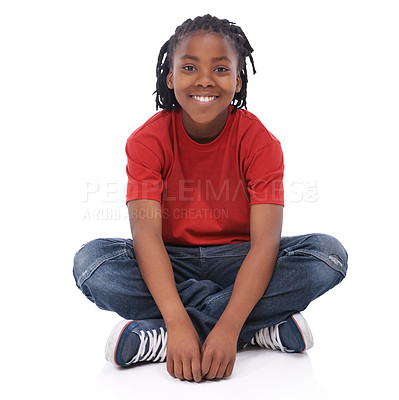 Buy stock photo Boy, child and portrait, smile in studio with casual clothes for fashion, positive mood and childhood on white background. T-shirt, jeans and simple outfit, African kid or youth sitting down