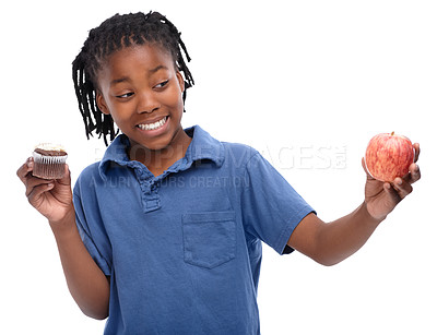 Buy stock photo Kid, apple and cupcake in studio with smile for thinking, contemplating and decision on snack. Black child, happy and unsure with choosing for lifestyle, fruit or sweet dessert on white background