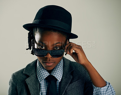 Buy stock photo Studio shot of a cool ethnic boy peering over his sunglasses