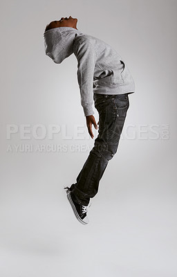 Buy stock photo Teen, fashion and jump with energy in studio with kid in streetwear hoodie on grey background. African, child and cool boy in the air with casual style, clothes and comfortable outfit in mockup