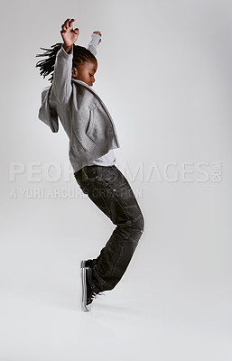 Buy stock photo Kid, fashion and dance with energy in studio with hoodie in streetwear on grey background. African, child and cool teenager or dancer with casual style, clothes and balance on shoes in mockup