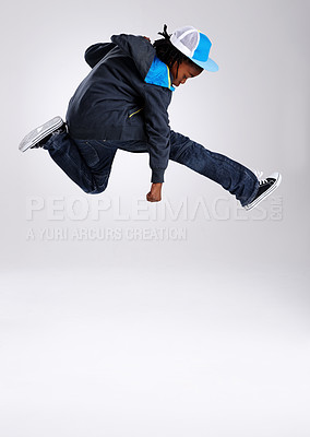 Buy stock photo Child, jump and dancing with hiphop and street style clothing in a studio with boy dancer. Trendy, energy and cool African kid with youth and rap music with white background and gen z clothes