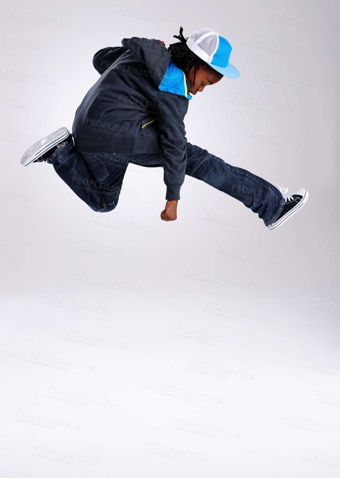 Buy stock photo Child, jump and dancing with hiphop and street style clothing in a studio with boy dancer. Trendy, energy and cool African kid with youth and rap music with white background and gen z clothes