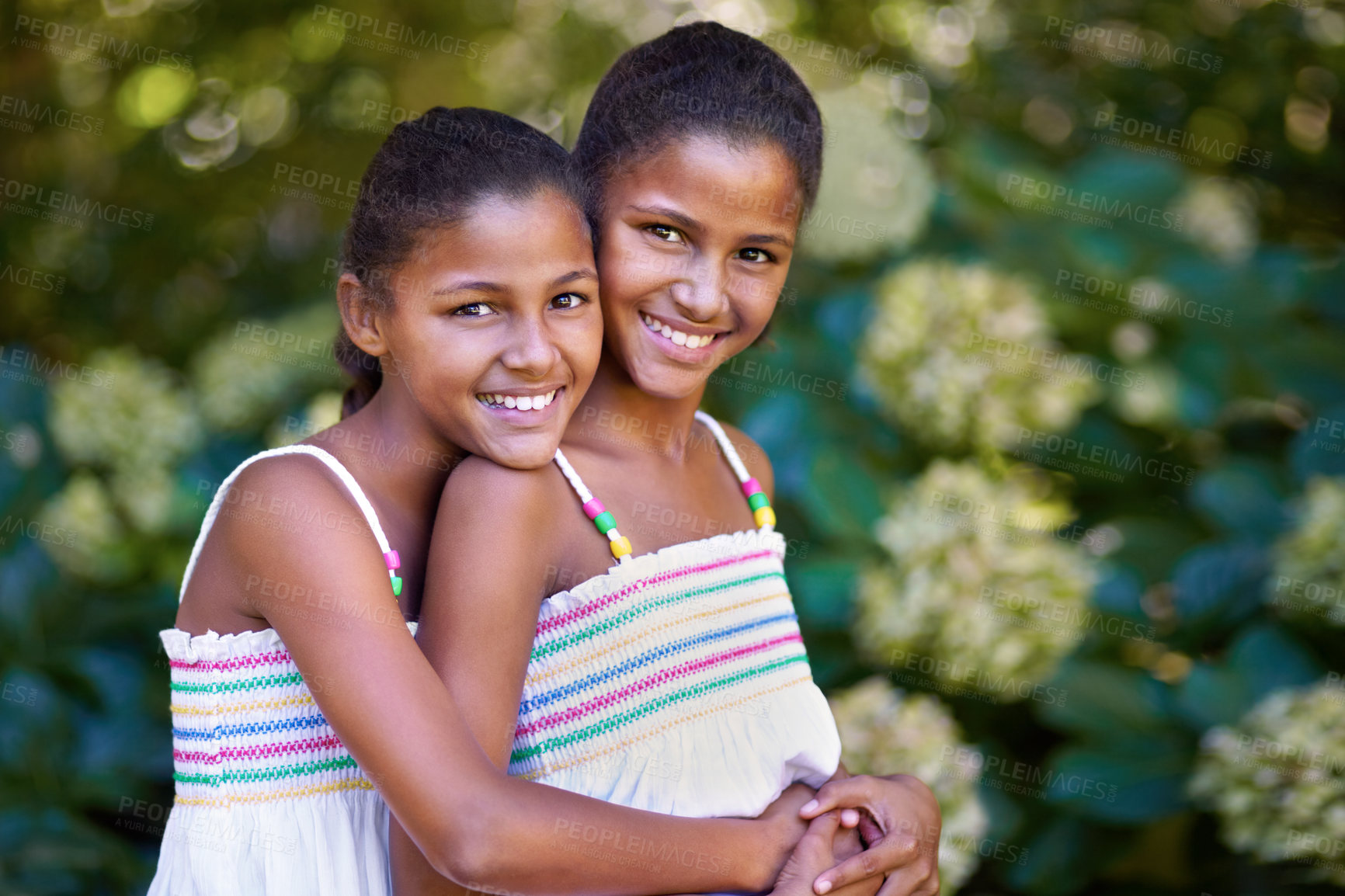 Buy stock photo Portrait of two twin sisters standing together outside