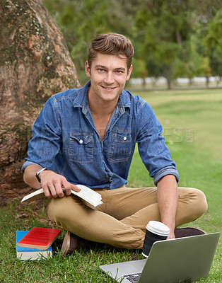 Buy stock photo Portrait of a handsome young man studying in the park with a laptop