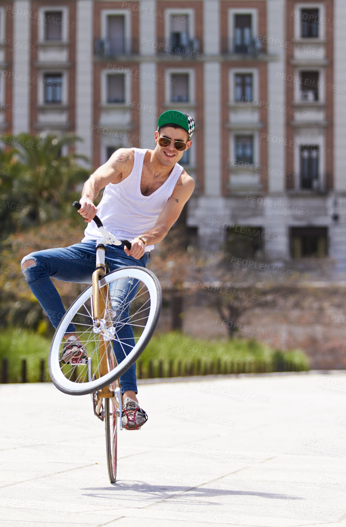 Buy stock photo Fitness, city and man riding a bicycle and practicing tricks and skills for a competition. Activity, hobby and casual young male person training and cycling outdoor with a bike in an urban town road.