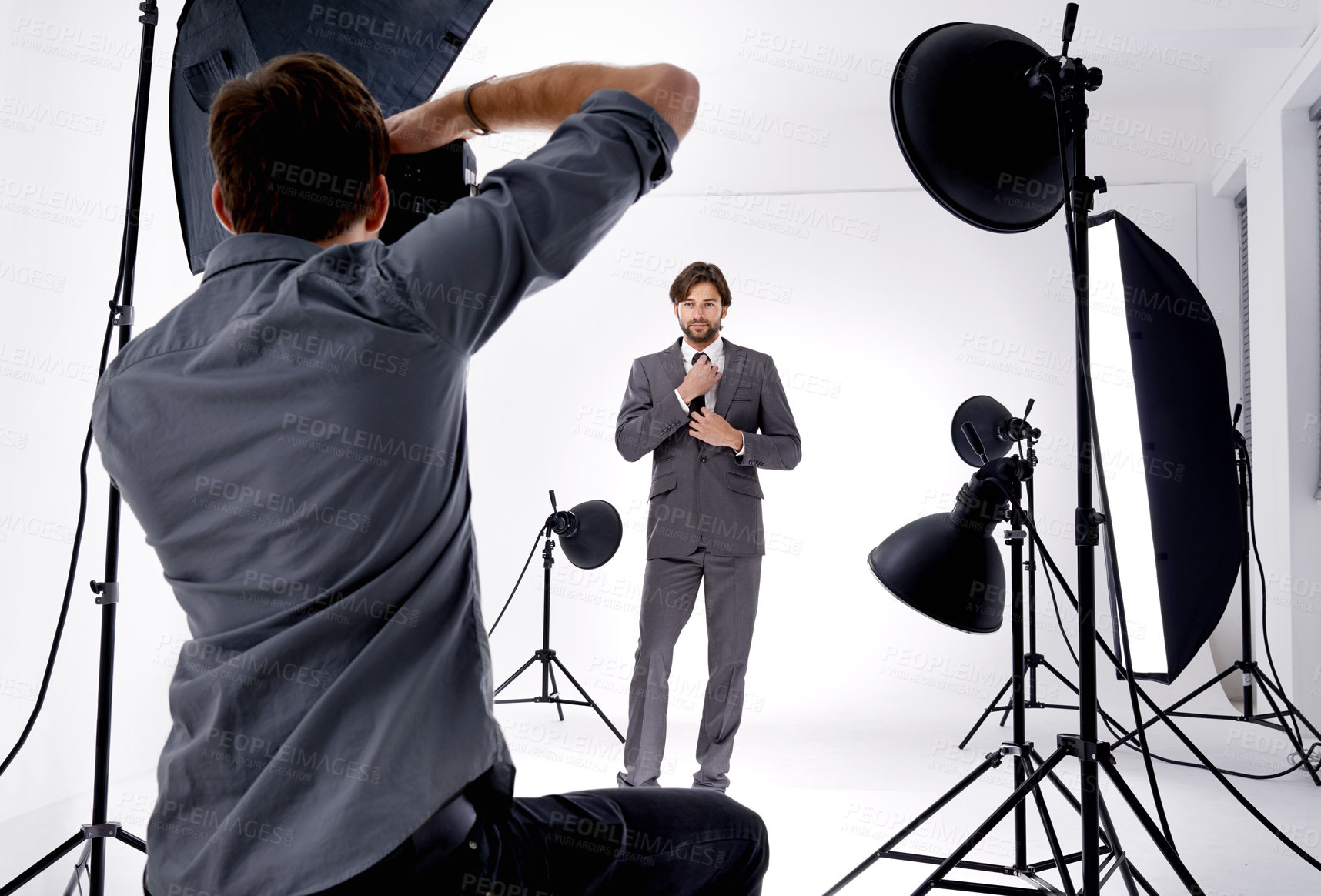 Buy stock photo Shot of a photographer working in his studio