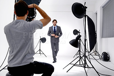 Buy stock photo Shot of a photographer working in his studio