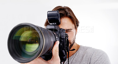 Buy stock photo Man, camera lens and photographer with technology in studio, press or media for news on white background. Photography, photo journalist and creative with paparazzi, equipment and closeup in studio