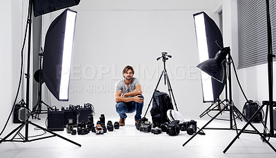 Buy stock photo Photographer, portrait or lighting with equipment in studio for career, behind the scenes or camera. Photography, guy and confidence with electronics, flash or shooting gear for photoshoot or passion