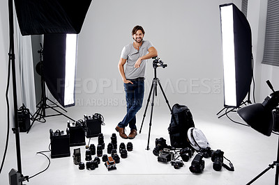 Buy stock photo Photographer, happy or lighting with equipment in studio for career, behind the scenes or camera. Photography, guy and confidence with electronics, portrait or shooting gear for photoshoot or passion