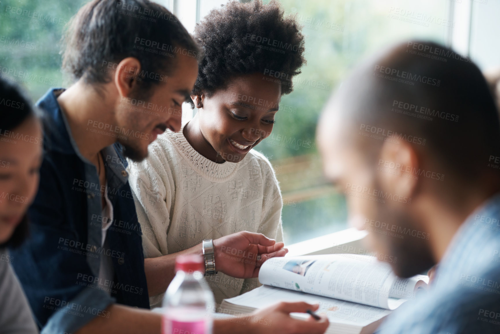 Buy stock photo A group of college students sitting together and studying