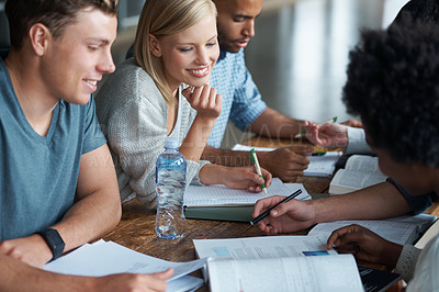Buy stock photo A group of college students sitting together and studying