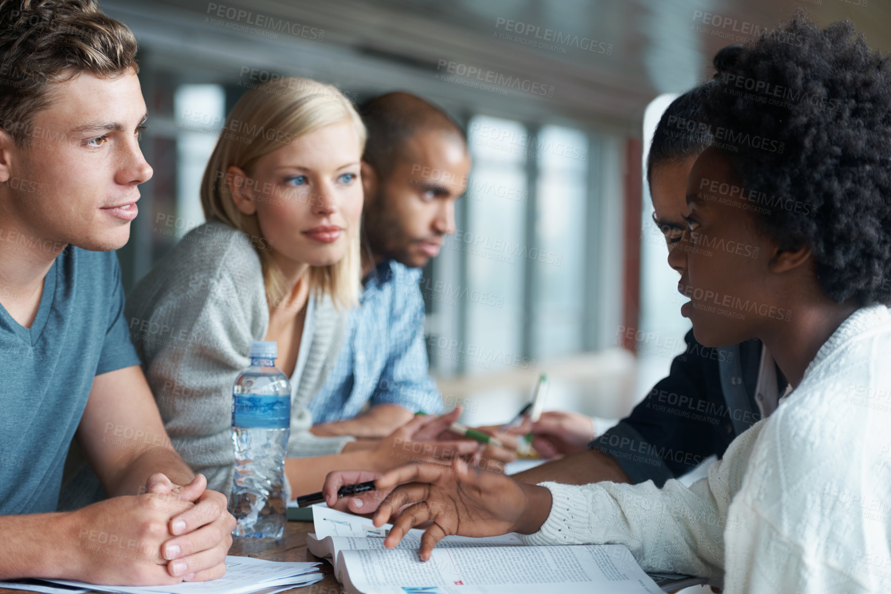 Buy stock photo Education, university and students studying and reading together, share ideas and research for project. People in library, academic discussion for assignment on campus, diversity and scholarship