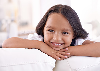 Buy stock photo Happy, relax and portrait of girl on sofa for playful, fun and resting on weekend in living room. Smile, childhood and face of young child alone on couch for vacation, holiday and free time in home