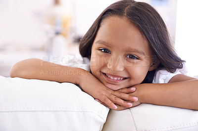 Buy stock photo Happy, relax and portrait of kid on sofa for playful, fun and resting on weekend in living room. Smile, childhood and face of young girl alone on couch for playing, comfortable and free time in home