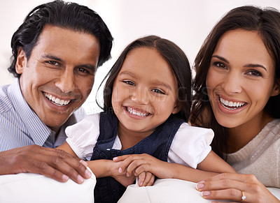 Buy stock photo Happy family, portrait and relax on sofa for love, bonding or care together at home. Face of Mother, father and little girl, daughter or child with smile in living room for holiday weekend at house