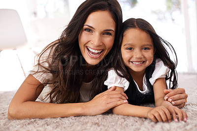Buy stock photo Happy mom, portrait and child lying on floor in relax for bonding, love or care together at home. Face of mother, parent and little girl, daughter or kid with smile in living room for family time